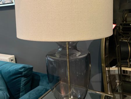 Tishan Florence Lamp. smokey grey glass  base with Natural linen shade available in outlet store For Sale